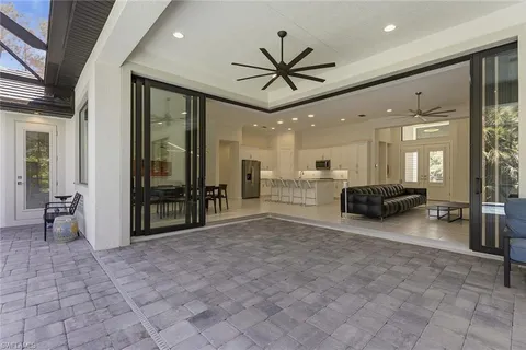 a living room with furniture a flat screen tv and a large window