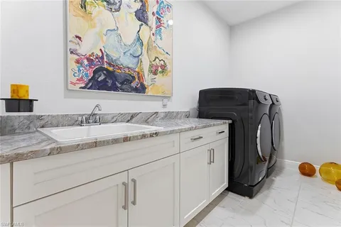 a bathroom with a granite countertop sink and a stove top oven