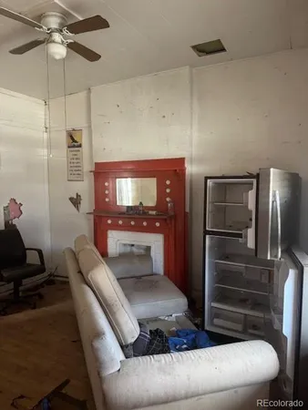 a living room with furniture and a ceiling fan