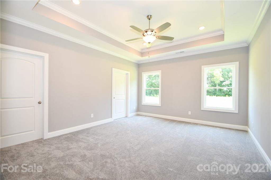 1710 McIntyre Road, Unit 4 Wingate, NC 28174 - Photo 8 of 14 an empty room with windows and fan