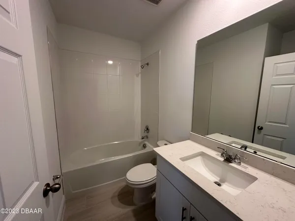 a bathroom with a sink toilet vanity and shower