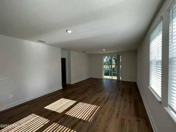 a view of wooden floor and windows in a room