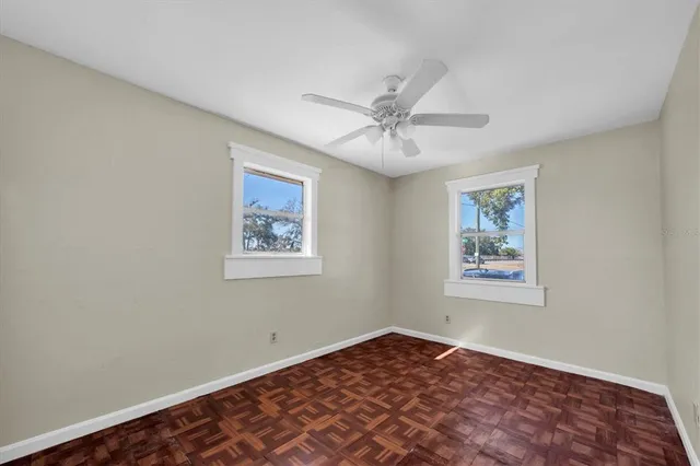 a view of an empty room with a window and closet