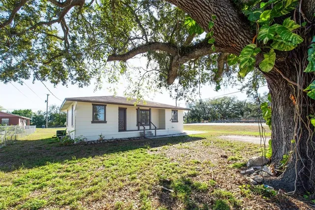 a front view of house with yard and green space