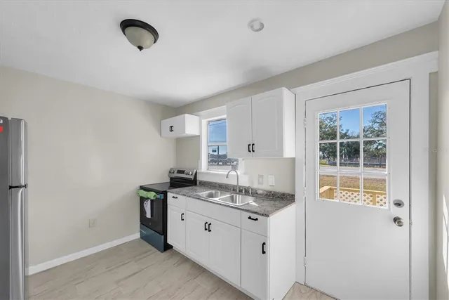 a kitchen with stainless steel appliances granite countertop a stove and a sink