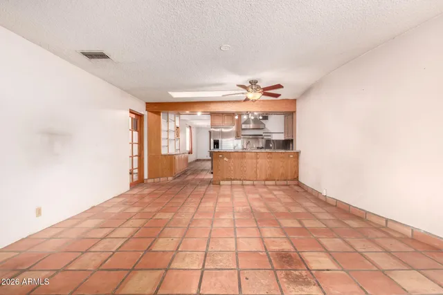 a big room with wooden floor and natural light