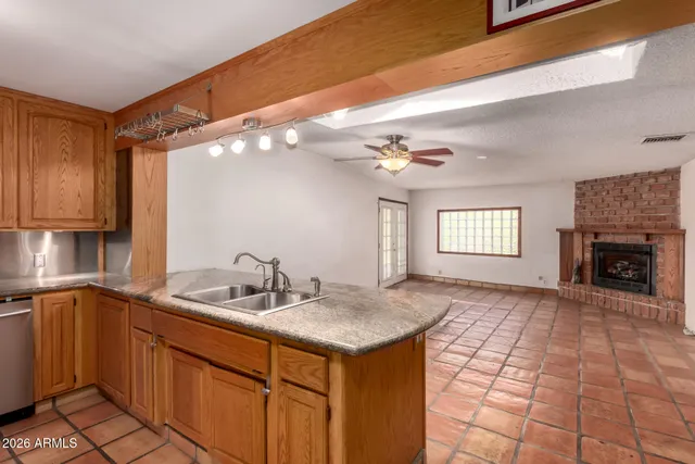 a kitchen with a sink cabinets and window
