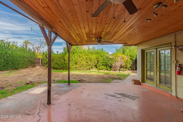 a view of a house with backyard and porch