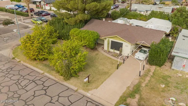 an aerial view of a house with a yard