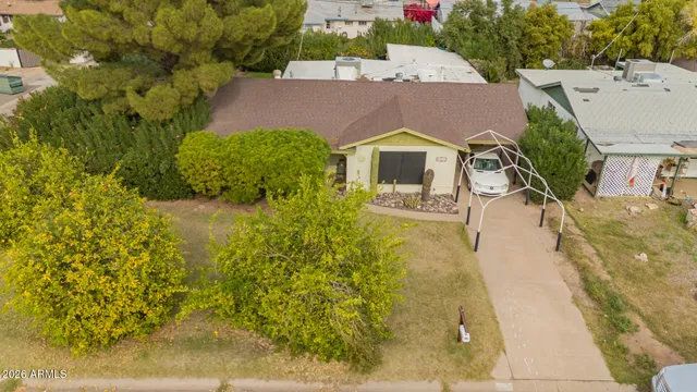 an aerial view of a house with a yard