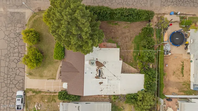 an aerial view of a house with outdoor space and swimming pool