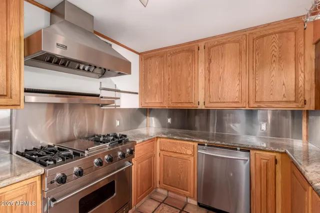 a kitchen with stainless steel appliances a sink and a stove