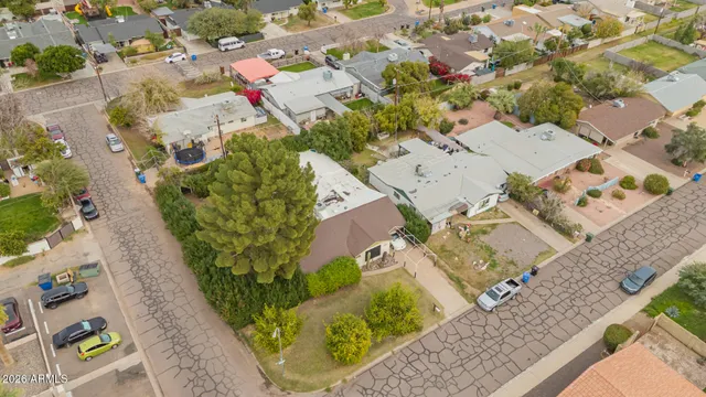 an aerial view of a house with a yard and garden