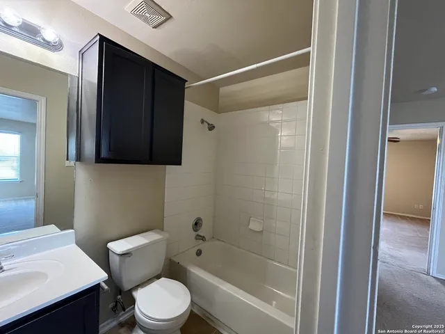 a white toilet sitting next to a bathroom sink
