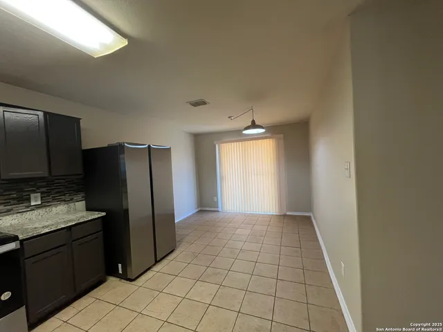 a kitchen with a refrigerator and a sink