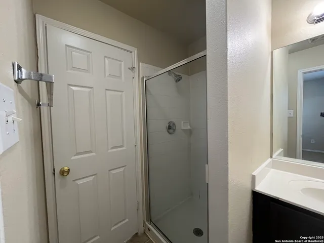 a bathroom with a shower and a sink