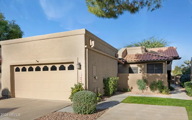 a front view of a house with a yard garage and outdoor seating