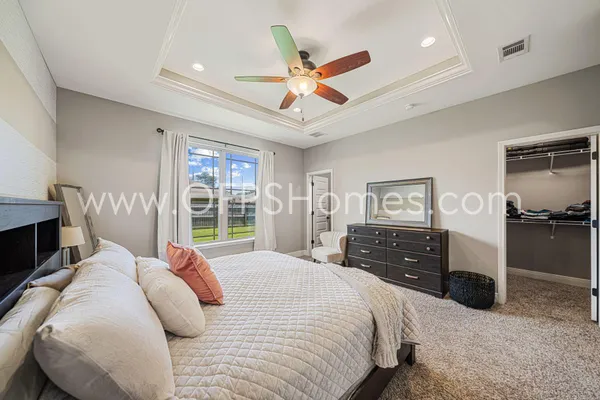 a bedroom with a bed and a chandelier