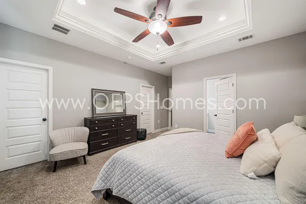 a bedroom with a bed dresser and furniture