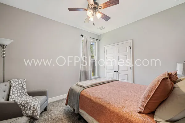 a bedroom with a bed and a chandelier