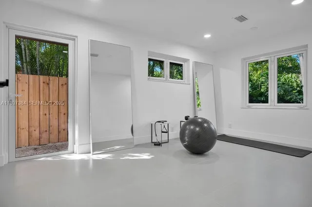 a room with a window and furniture