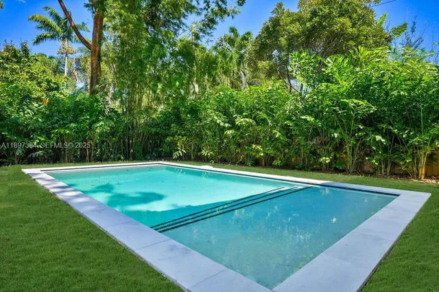 a view of green field with a tree