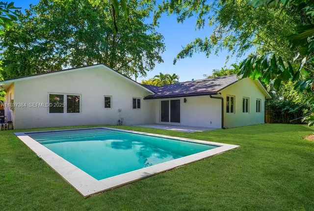 a view of a white house with a yard