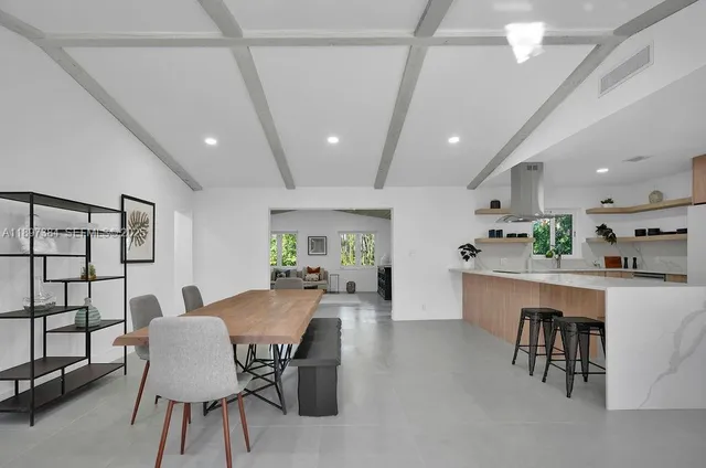 a view of a dining room with furniture and window