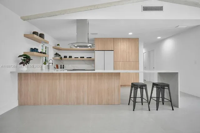 a kitchen with stainless steel appliances kitchen island granite countertop a sink and cabinets