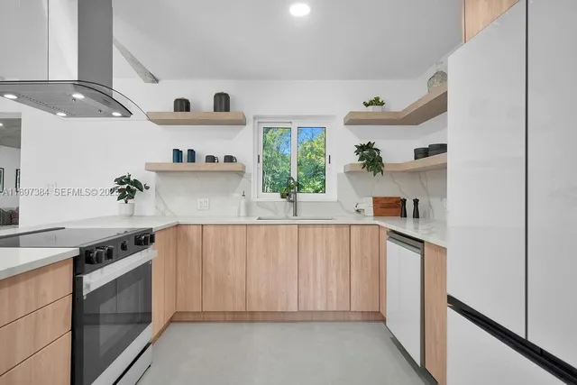 a kitchen with a stove a sink and a refrigerator