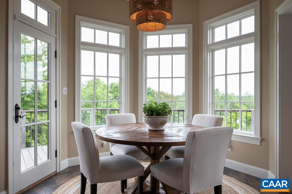 513 Half Mile Branch Road Crozet, VA 22932 - Photo 14 of 57 a view of a dining room with furniture window and wooden floor