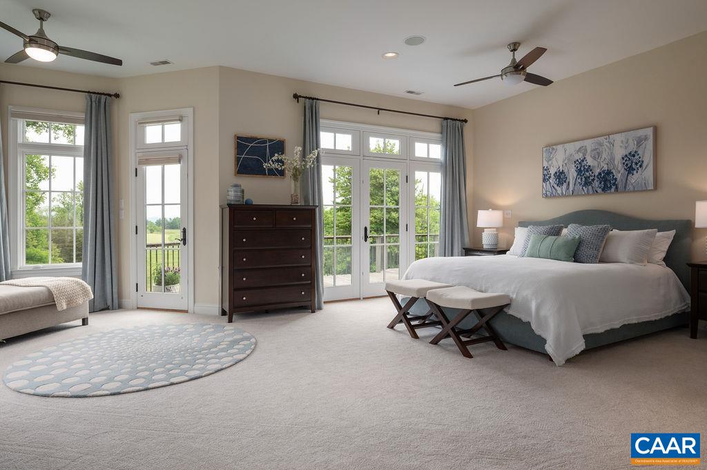 513 Half Mile Branch Road Crozet, VA 22932 - Photo 21 of 57 a spacious bedroom with a bed a dresser and a large window