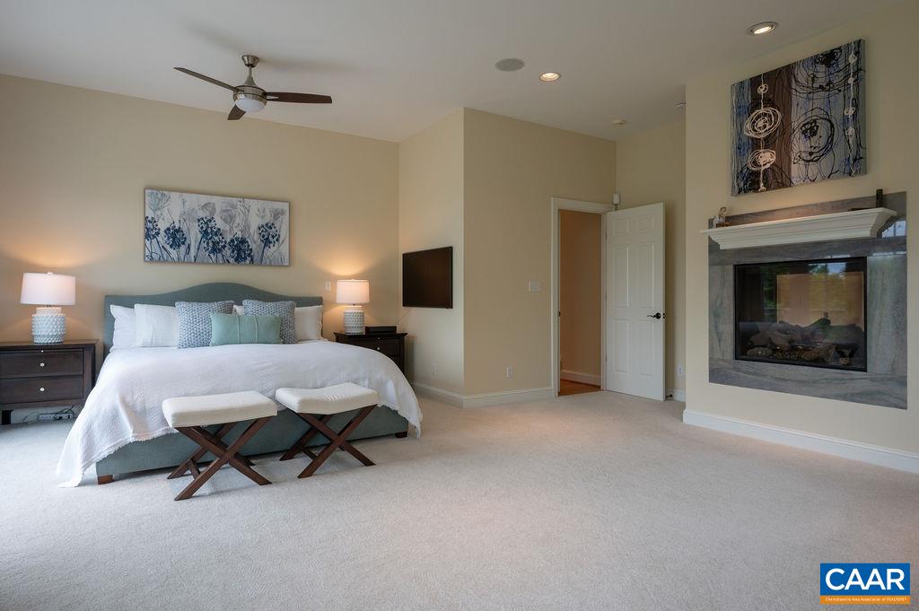 513 Half Mile Branch Road Crozet, VA 22932 - Photo 23 of 57 a spacious bedroom with a bed and a ceiling fan