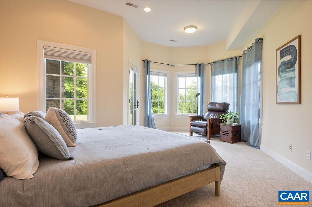 513 Half Mile Branch Road Crozet, VA 22932 - Photo 30 of 57 a bedroom with a bed and large windows