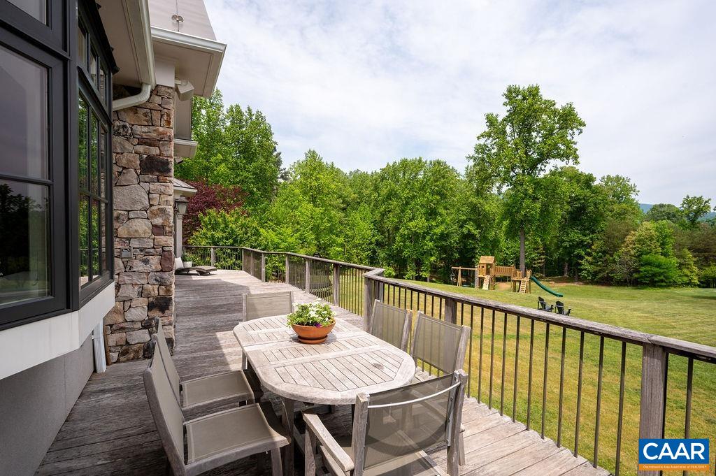 513 Half Mile Branch Road Crozet, VA 22932 - Photo 39 of 57 a view of a patio with a table and chairs