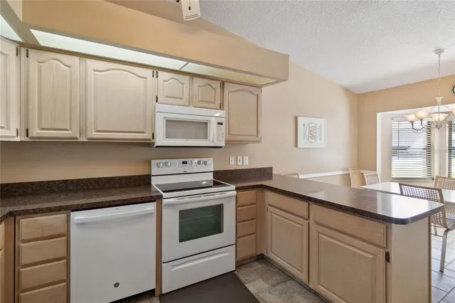 a living room with furniture ceiling fan and a wooden floor