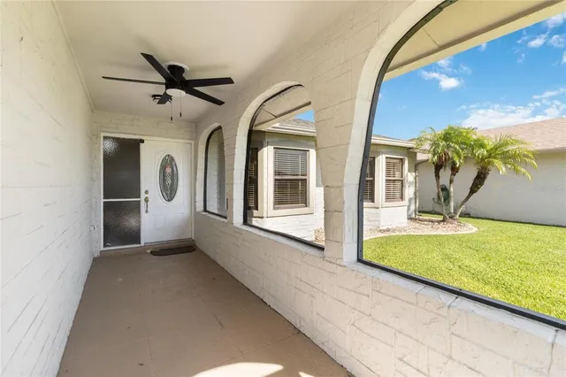 a view of a house with a yard and basket ball court