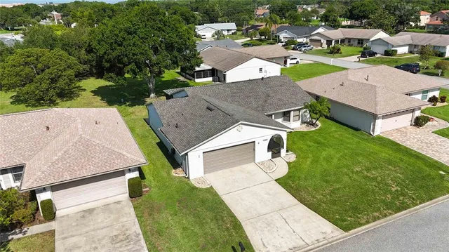 an aerial view of a house with a garden and swimming pool