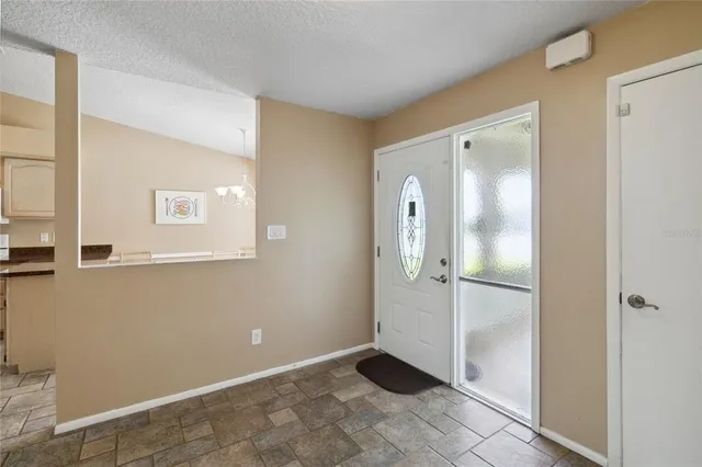 a kitchen with granite countertop a sink and dishwasher with a dining table