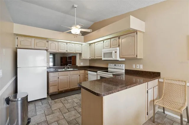 a living room with furniture a flat screen tv and a window