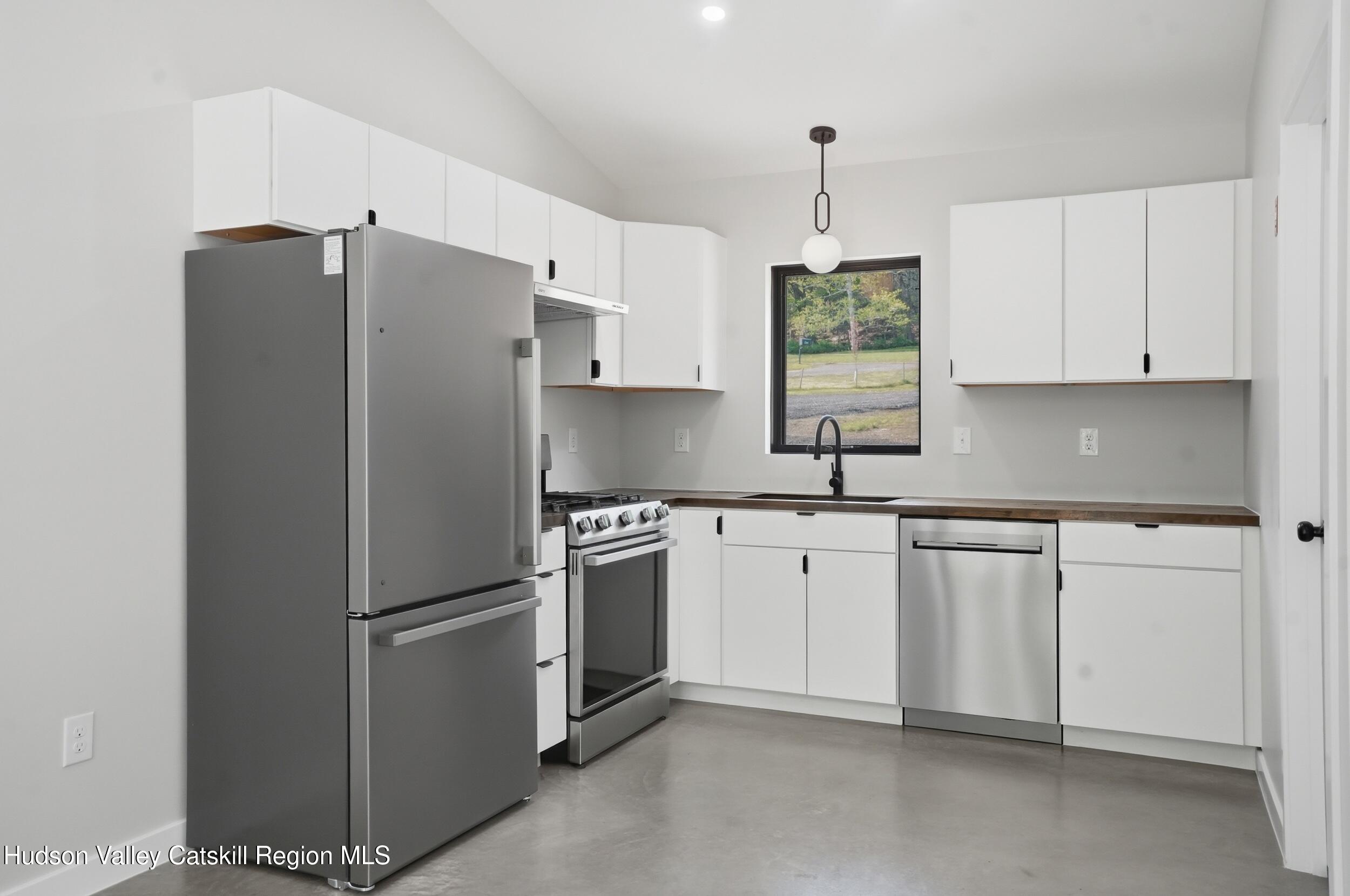 349 High Point Mountain Road West Shokan, NY 12494 - Photo 13 of 25 a kitchen with stainless steel appliances granite countertop a refrigerator sink and cabinets