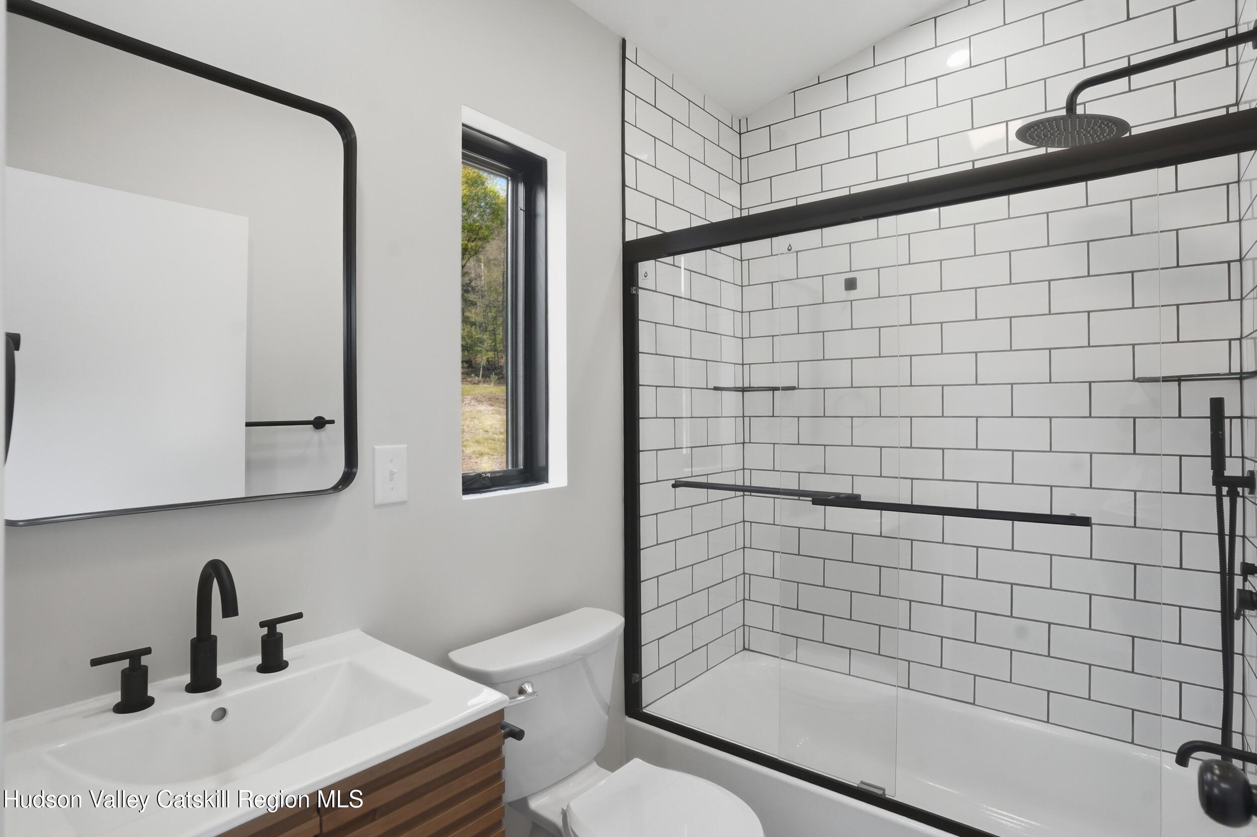 349 High Point Mountain Road West Shokan, NY 12494 - Photo 19 of 25 a bathroom with a sink a toilet and shower