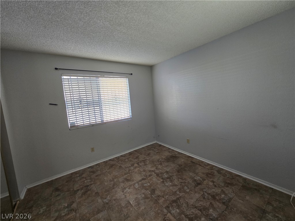 6750 Del Rey Avenue, Unit 133 Las Vegas, NV 89146 - Photo 23 of 34 An adaptable living space features patterned tile flooring and natural light.