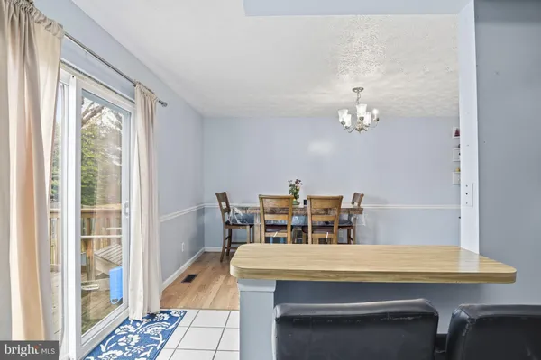 a dining room with furniture and chandelier