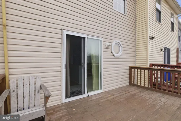 a view of a house with wooden deck