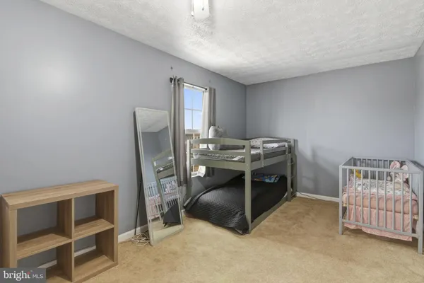 a bedroom with a bed and a chair