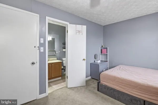 a bedroom with a bed and a view of bathroom