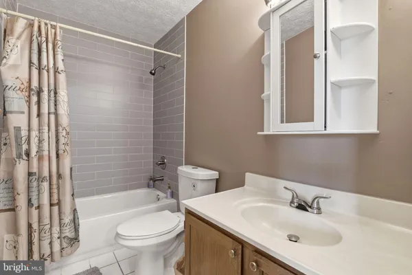 a bathroom with a sink toilet tub and shower
