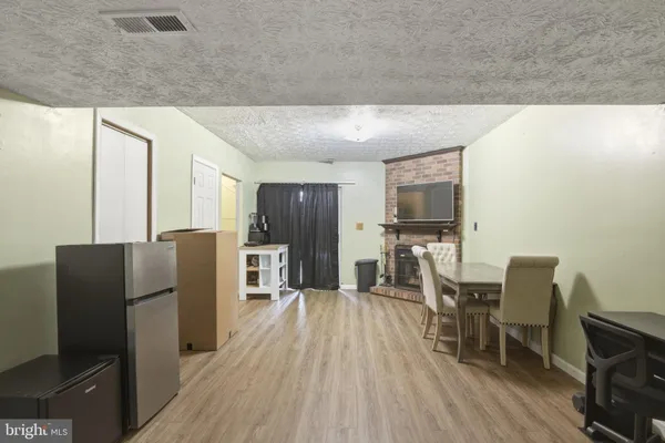 a kitchen with stainless steel appliances granite countertop a refrigerator oven a sink dishwasher and wooden cabinets with wooden floor