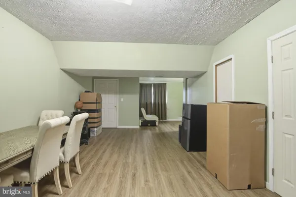 a view of a kitchen with furniture and wooden floor